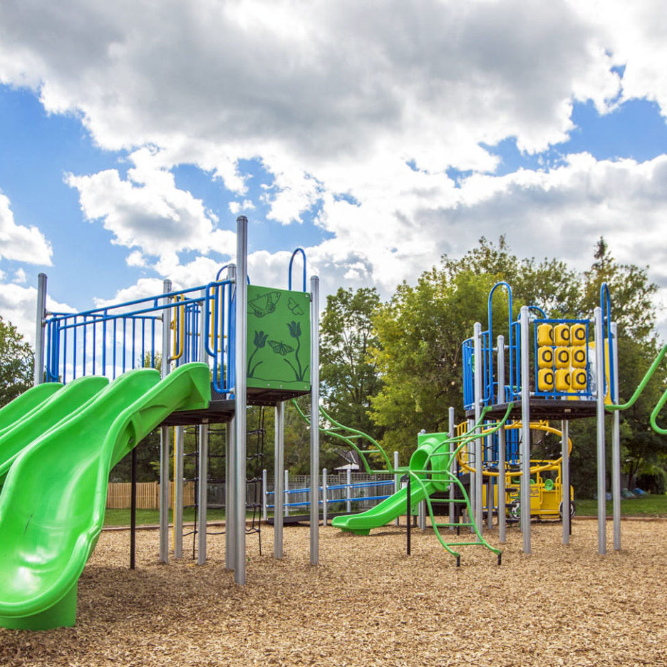 Victoria Park 4 A playground with slides and swings in the sand.