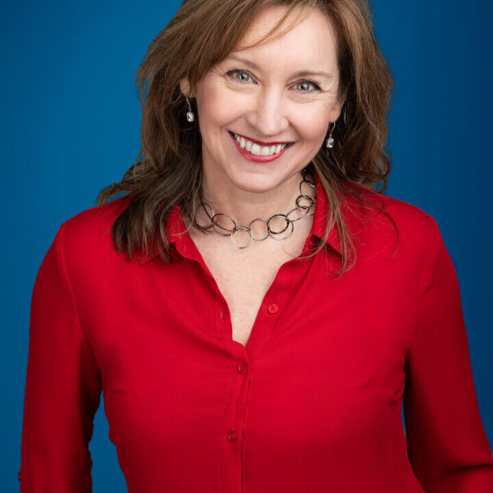 Christina-Doracin-2blue A woman in red shirt smiling for the camera.